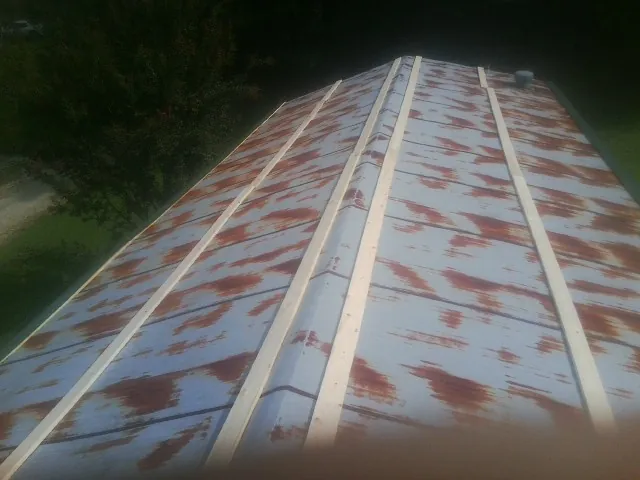 Rusted metal roof panels with new wood purlins before replacement — Storm Damage Roof Repair in Sherrills Ford by Roofing Brothers
