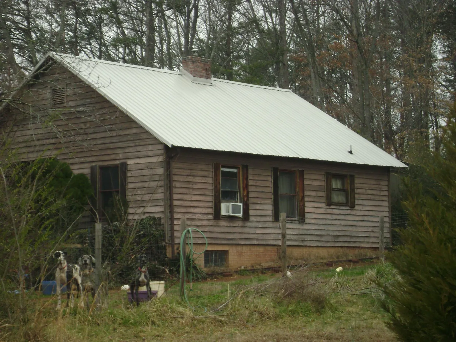 White metal roof on an old wood sided farmhouse, from a Metal Roof Installation job in Sherrills Ford